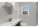 Updated bathroom with a modern vanity, mirror, natural light, and a shower at 102 S College Ave, Kenly, NC 27542