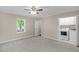 Bedroom features neutral carpet, ceiling fan, and a convenient laundry area with washer and dryer at 102 S College Ave, Kenly, NC 27542