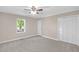 Bedroom with neutral carpet, a ceiling fan, natural light from a window, and closet space at 102 S College Ave, Kenly, NC 27542