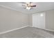 Bedroom with neutral carpet, natural light, a ceiling fan, and closet with sliding doors at 102 S College Ave, Kenly, NC 27542