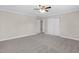 Neutral bedroom with a ceiling fan and gray carpet, and lots of closet space at 102 S College Ave, Kenly, NC 27542