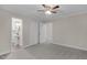 Neutral bedroom features a ceiling fan, gray carpet, and ensuite with sink and toilet at 102 S College Ave, Kenly, NC 27542