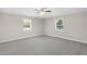 Neutral bedroom with soft gray carpet and bright light from the two windows at 102 S College Ave, Kenly, NC 27542