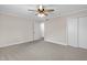 Bedroom with neutral carpet, natural light, ceiling fan, and a double-door closet at 102 S College Ave, Kenly, NC 27542