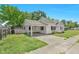 Exterior angle shot of home showing carport, landscaping and driveway at 102 S College Ave, Kenly, NC 27542