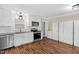 Well-lit kitchen offers stainless steel appliances, granite countertops, and wood flooring at 102 S College Ave, Kenly, NC 27542