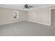 Spacious living room features neutral carpeting and a ceiling fan at 102 S College Ave, Kenly, NC 27542
