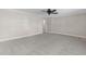 Bright living room with fresh carpeting and a modern ceiling fan at 102 S College Ave, Kenly, NC 27542
