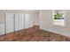 Inviting living room featuring hardwood floors, white cabinetry, and natural light from the window at 102 S College Ave, Kenly, NC 27542