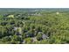 Aerial view of the home surrounded by mature trees at 102 Winged Foot Ct, Mebane, NC 27302