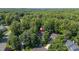 Aerial view of a home tucked away in trees at 102 Winged Foot Ct, Mebane, NC 27302