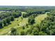 An aerial view shows the manicured golf course and its lush landscaping at 102 Winged Foot Ct, Mebane, NC 27302