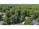 Aerial view of homes nestled in a lush, wooded neighborhood at 102 Winged Foot Ct, Mebane, NC 27302