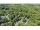 Aerial view of home nestled among mature trees at 102 Winged Foot Ct, Mebane, NC 27302