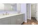 Bathroom with a double sink vanity, framed mirror, and a view of the walk-in closet at 102 Winged Foot Ct, Mebane, NC 27302