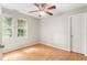 A bedroom featuring hardwood floors, a ceiling fan, and two windows at 102 Winged Foot Ct, Mebane, NC 27302