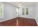 Empty bedroom featuring hardwood floors, bright windows, and a ceiling fan at 102 Winged Foot Ct, Mebane, NC 27302