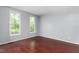 Bedroom featuring hardwood floors and large windows offering great natural light at 102 Winged Foot Ct, Mebane, NC 27302