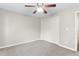 A neutral carpeted bedroom featuring closet and ceiling fan at 102 Winged Foot Ct, Mebane, NC 27302