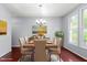 Elegant dining room featuring a wood table with seating for six and large windows at 102 Winged Foot Ct, Mebane, NC 27302