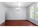 Spacious dining room featuring hardwood floors and a modern chandelier at 102 Winged Foot Ct, Mebane, NC 27302