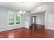 Bright dining room with hardwood floors and natural light from large windows at 102 Winged Foot Ct, Mebane, NC 27302