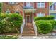 Inviting front entrance with brick steps, white railings, and lush green bushes at 102 Winged Foot Ct, Mebane, NC 27302