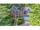 Aerial view of a charming two-story home with brick and siding, red shutters, and a manicured front yard at 102 Winged Foot Ct, Mebane, NC 27302