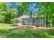 Rear exterior showing the house with screened-in porch and deck at 102 Winged Foot Ct, Mebane, NC 27302