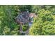 A beautiful exterior view of a two-story home surrounded by lush trees and a well-maintained lawn at 102 Winged Foot Ct, Mebane, NC 27302