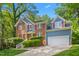 Beautiful two-story home with brick and siding, red shutters, and manicured landscaping at 102 Winged Foot Ct, Mebane, NC 27302