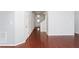 Hallway with doors and hardwood flooring leading to the stairs at 102 Winged Foot Ct, Mebane, NC 27302