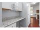 Hallway with built-in desk, storage and hardwood flooring leading to the kitchen at 102 Winged Foot Ct, Mebane, NC 27302