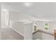 Hallway featuring carpet floors, white trim, and access to a second story space at 102 Winged Foot Ct, Mebane, NC 27302