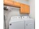 Laundry room featuring a washer, dryer, and storage cabinets at 102 Winged Foot Ct, Mebane, NC 27302