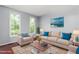 Bright living room with comfortable seating and natural light from large windows at 102 Winged Foot Ct, Mebane, NC 27302
