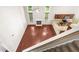 Aerial view of a two-story living room with kitchen, fireplace, hardwood floors, and stairs at 102 Winged Foot Ct, Mebane, NC 27302