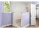 Open shower featuring white subway tile surround, handheld shower head, and natural light at 102 Winged Foot Ct, Mebane, NC 27302