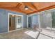 Spacious sunroom with wood ceiling, tile flooring, and sliding glass doors to the exterior at 102 Winged Foot Ct, Mebane, NC 27302