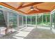 Bright sunroom featuring a wood ceiling, tile floor, and large windows at 102 Winged Foot Ct, Mebane, NC 27302