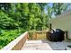 Spacious back deck featuring a wooden railing and grill, perfect for outdoor entertaining and relaxation at 10304 Stallion Way, Bahama, NC 27503