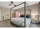 Bright bedroom with a canopy bed, soft carpet, and natural light from large windows at 10304 Stallion Way, Bahama, NC 27503
