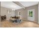 Bright dining room with a stylish light fixture, table with seating, and adjacent white door at 10304 Stallion Way, Bahama, NC 27503