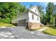 Spacious garage with unique doors, brick foundation, and a paved driveway at 10304 Stallion Way, Bahama, NC 27503