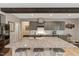 Spacious kitchen with gray cabinets, stainless steel appliances, and a large granite island with seating at 10304 Stallion Way, Bahama, NC 27503