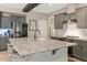 Well-designed kitchen with stainless steel appliances, gray cabinets, granite countertops, and large central island at 10304 Stallion Way, Bahama, NC 27503