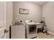 Functional laundry room equipped with modern washer, dryer, and ample counter space at 10304 Stallion Way, Bahama, NC 27503