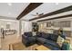Open concept living space featuring exposed beams, modern furnishings, adjacent dining and kitchen areas at 10304 Stallion Way, Bahama, NC 27503