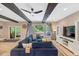 Comfortable living room featuring exposed wood beams, sliding glass door to the deck, and natural light at 10304 Stallion Way, Bahama, NC 27503