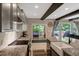 Open floor plan with kitchen island and sink leading to outdoor deck with seating at 10304 Stallion Way, Bahama, NC 27503